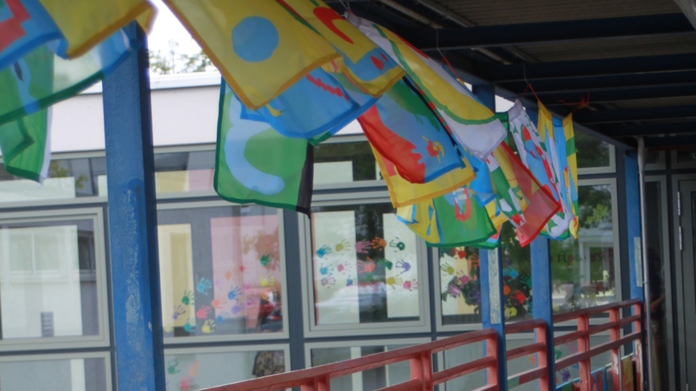 Bunte Fahnen GS Rastpfuhl wehende bunte Fahnen Gang zur GS Rastpfuhl